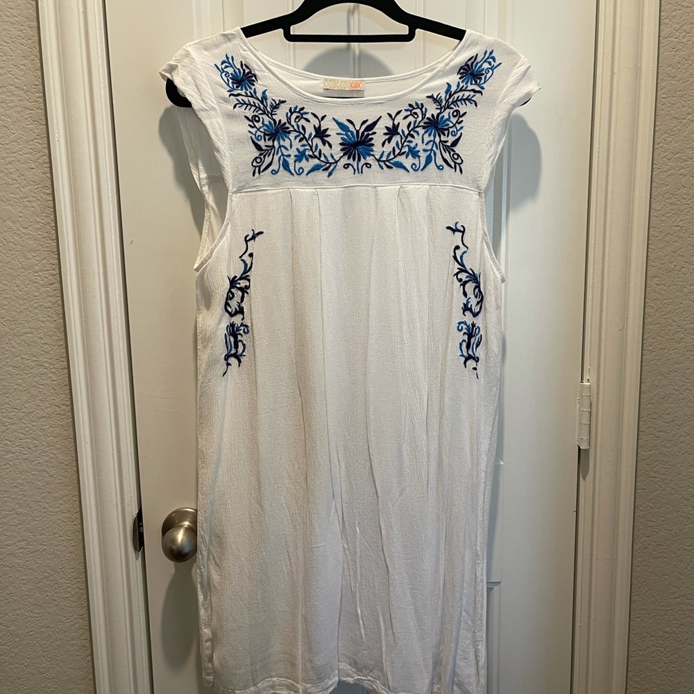 White dress with blue embroidered details
